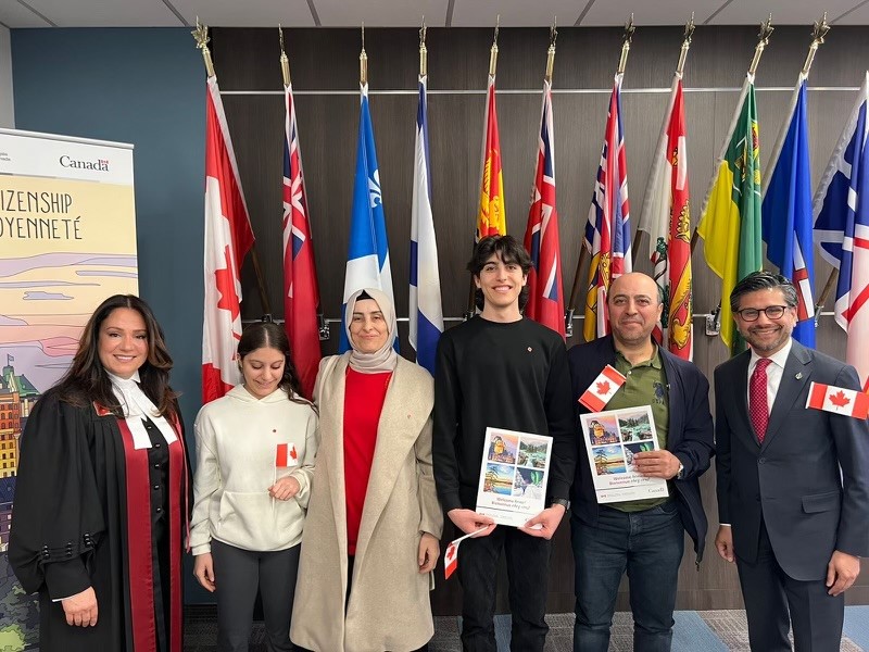 Aydin and his family pose for photo at the Canadian citizenship ceremony